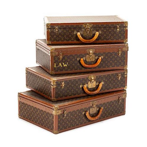 Four Louis Vuitton Suitcases Height of largest 20 x width 29 3/4 x depth 8 1/2 inches.