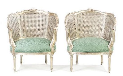 A Pair of Louis XVI Style Silvered Caned Bergeres, Height 33 7/8 inches.