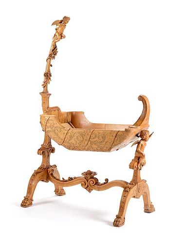 An Italian Carved Cradle Height 66 1/2 x length 41 x depth 18 1/4 inches.