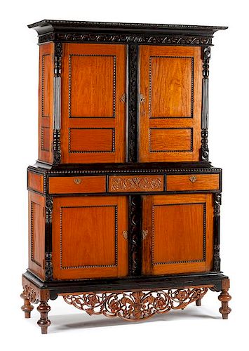 A Dutch Colonial Parcel Ebonized Satinwood Cabinet Height 81 x width 50 x depth 20 1/2 inches.