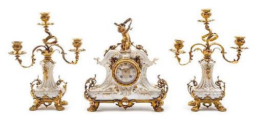 A Berlin (K.P.M.) Porcelain and Gilt Bronze Clock Garniture Height of candelabra 13 inches.