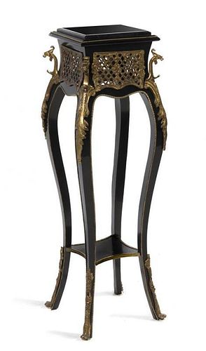 A Napoleon III Style Gilt Metal Mounted Ebonized Pedestal Table, Height 43 1/4 inches.