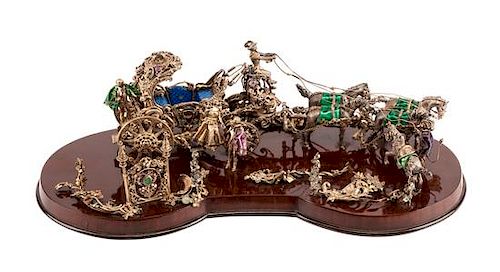 An Austrian 'Jeweled' and Enameled Silver Model of a Carriage, 20th Century, in the form of a coach lead by four horses.