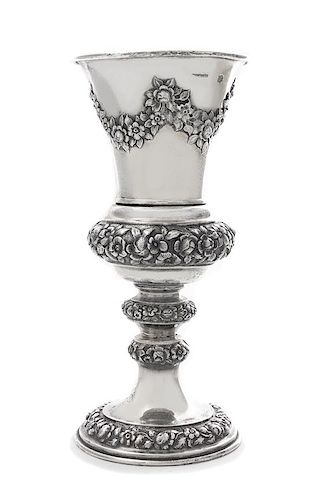* An Austrian Silver Chalice, J. Reiner, Vienna, 1847, the tapering cup worked to show repousee floral swags, raised on a simila