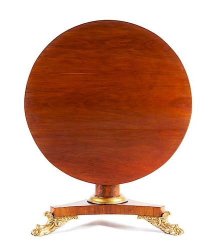 A William IV Parcel Gilt Mahogany Center Table Height 28 x diameter of top 41 inches.