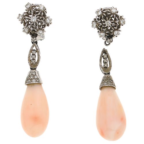 A coral and diamond palladium silver pair of earrings.