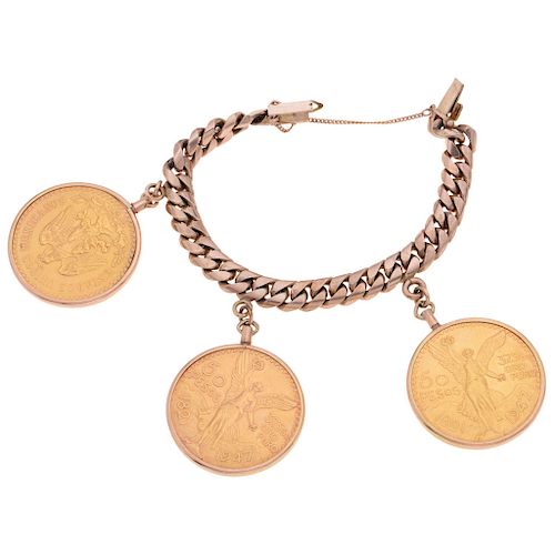 A 10K yellow gold bracelet with three 21.6K yellow gold coins.