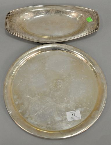 Two sterling silver trays. lg. 13 1/4 in., & dia. 12 in., 28.4 total t oz. 
Provenance: Estate of Kenneth Jay Lane