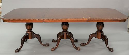 Mahogany triple triple pedestal dining table with ball and claw feet plus two extra 20 inch leaves. ht. 30 in., top closed: 48" x 96...