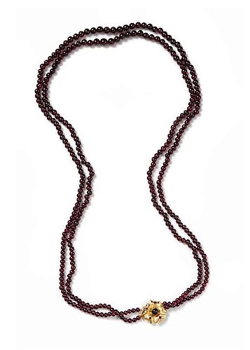 * A Graduated Double Strand Garnet Bead Necklace,