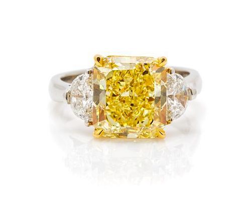 * A Platinum, 18 Karat Yellow Gold, Fancy Intense Yellow Diamond and Diamond Ring, 6.20 dwts.