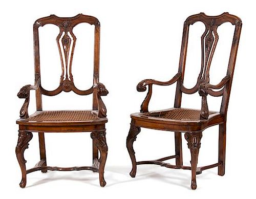 A Pair of Italian Carved Walnut Open Armchairs Height 44 x width 23 x depth 21 inches.