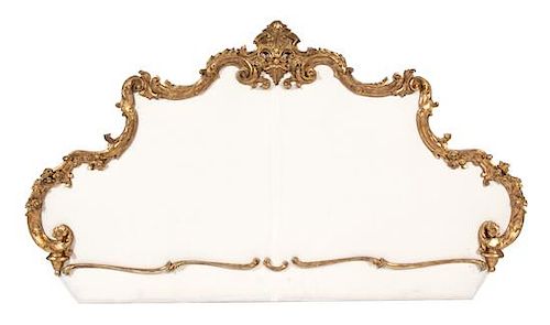 A Rococo Style Carved Giltwood and Upholstered Headboard Height 48 x width 78 inches.