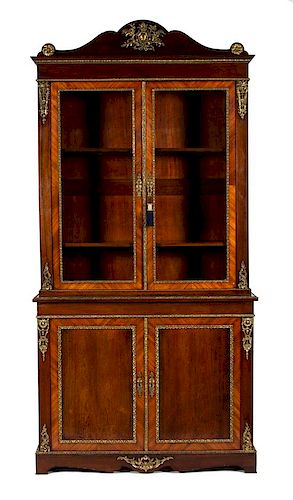 A French Empire Gilt Metal Mounted Kingwood and Mahogany Bookcase Height 101 x width 50 x depth 21 inches.