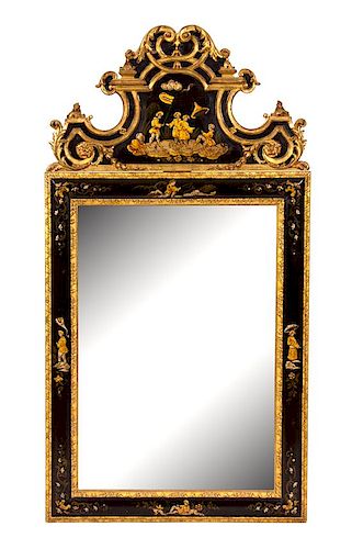 A George I Style Carved Parcel Gilt and Japanned Wall Mirror Height 64 x width 32 1/2 inches.