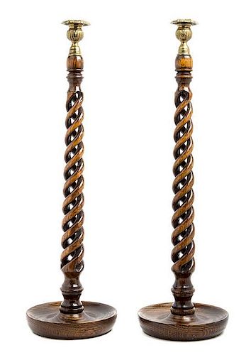 A Pair of English Gilt Metal Mounted Oak Candlesticks Height 22 1/2 inches.