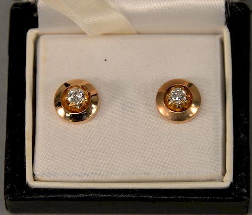 Pair of 14 karat and diamond pierced earrings, each diamond approximately .30 carat.