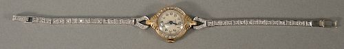 14 karat gold women's watch by Imperial with platinum and diamond band, lg. 6 1/8 in., total weight 15.1 grams.