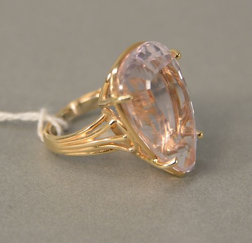 14 karat gold ring, set with pear shaped topaz, light pink color. size 6 with horseshoe ring guard, 11.4 grams total weight