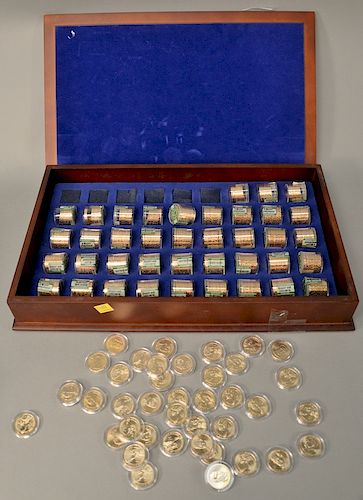 $486.00 face value of miscellaneous golden presidential dollars in wooden box, uncirculated.
