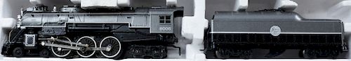 Two Lionel trains in display cases to include Fairbanks morse train master and 8006 Atlantic Coast line 4-6-4, new in original boxes...