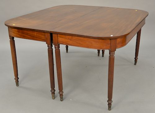 Sheraton mahogany two part dining table with brass capped feet, circa 1830. each part: ht. 29 in., wd. 54 in.