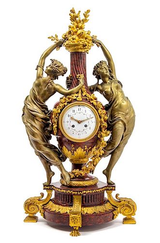 A French Gilt and Patinated Bronze Figural Mantel Clock Height 30 3/4 inches.