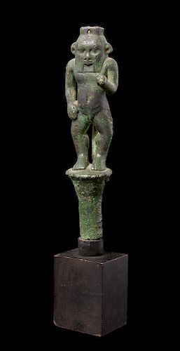 * An Egyptian Bronze Bes Standing on a Papyrus Umbel Height 7 inches.