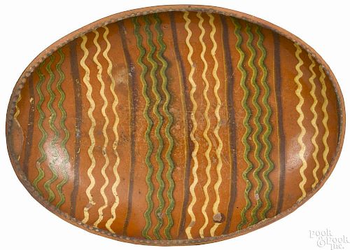 American redware oval loaf dish, mid 19th c., with yellow and green wavy slip line decoration