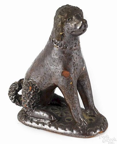 Pennsylvania redware seated spaniel, 19th c., with a manganese glaze, 4 1/4'' h.