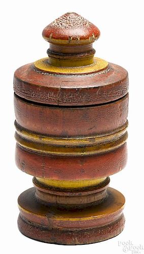 Turned and painted lidded wood canister, 19th c., retaining its original red and yellow surface