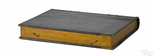 Carved and painted pine book-form box, 19th c., the lid decorated with a stenciled basket