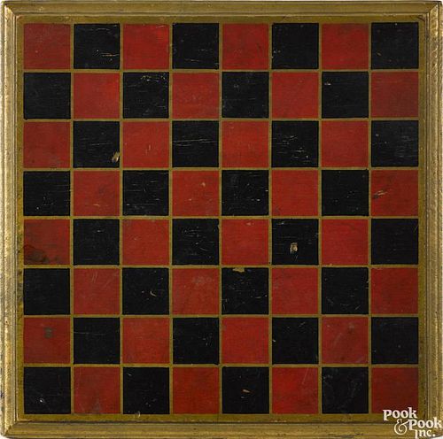 Painted pine gameboard, ca. 1900, retaining its original red and black squares on a gilt ground