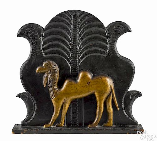 Pennsylvania carved and painted plaque, late 19th c., of a camel with a stylized tree background
