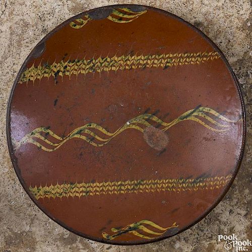 Pennsylvania or New Jersey redware charger, 19th c., with yellow and green slip decoration
