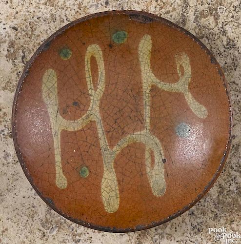 Miniature Pennsylvania redware pie plate, 19th c., with yellow slip loop and green dot decoration