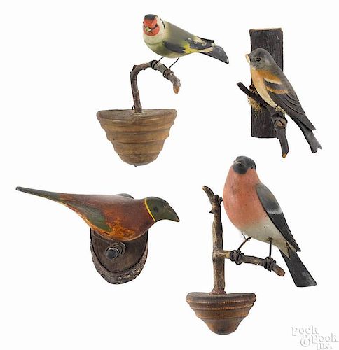 Four carved and painted songbirds, early 20th c., on twig perches, tallest - 7 3/4''.