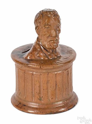 Pennsylvania redware bank, 19th c., with a bust of Abraham Lincoln, 5 1/8'' h.