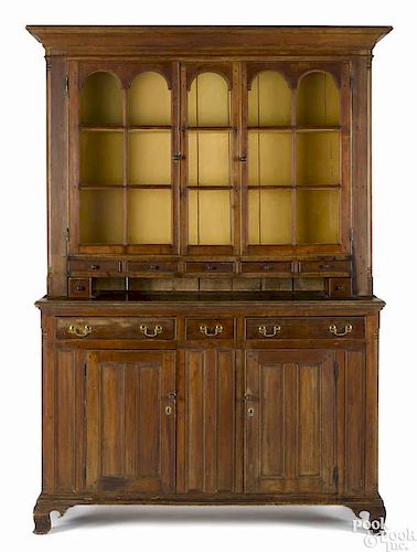 Pennsylvania poplar two-part Dutch cupboard, ca. 1800, with arched glazed panel doors