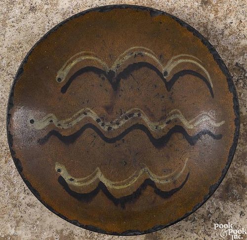 Pennsylvania redware charger, 19th c., with yellow and brown slip wavy lines, 11 1/2'' dia.