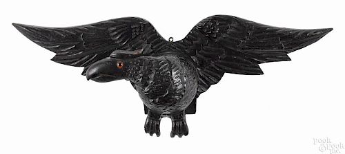 Carved and painted poplar eagle wall plaque, ca. 1900, retaining its original ebonized surface