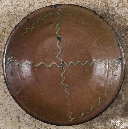 Pennsylvania redware shallow bowl, 19th c., with yellow and green wavy line slip decoration