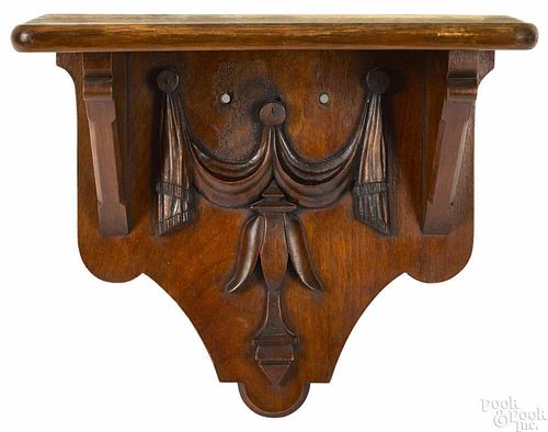 Pennsylvania carved walnut shelf, late 19th c., with applied tulip and swag, 12'' h., 14'' w.