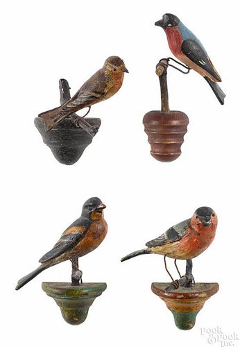 Four carved and painted songbirds, early 20th c., on twig perches, approx. 5 1/2'' h.