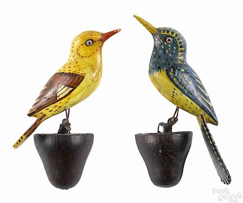 Pair of carved and painted songbirds, early 20th c., on pine perches, 7'' h.