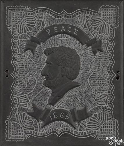 Carved slate plaque with a bust of Abraham Lincoln, inscribed Peace 1865, 17'' x 14 1/4''.