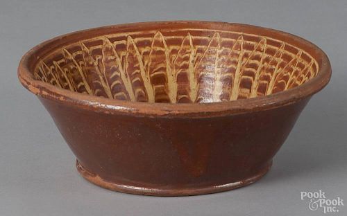 Mid-Atlantic redware bowl, 19th c., with yellow slip decoration, possibly Adams Pottery