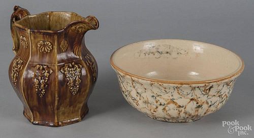 Spongeware mixing bowl, ca. 1900, 5 1/2'' h., 12 1/4'' w., together with a Rockingham glaze pitcher
