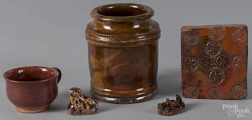 Five pieces of redware, to include a small jar, a handled cup, a block stamp