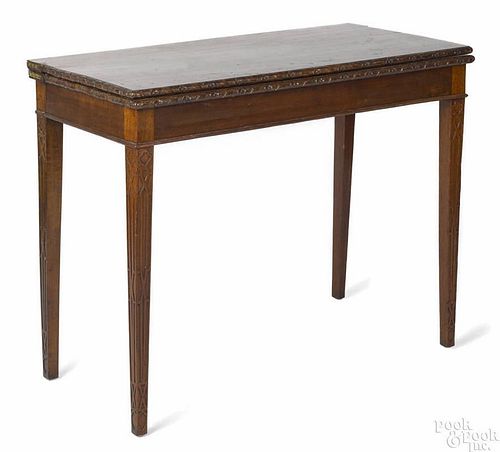 George III mahogany games table, ca. 1770, the top with a floral and ribbon carved edge